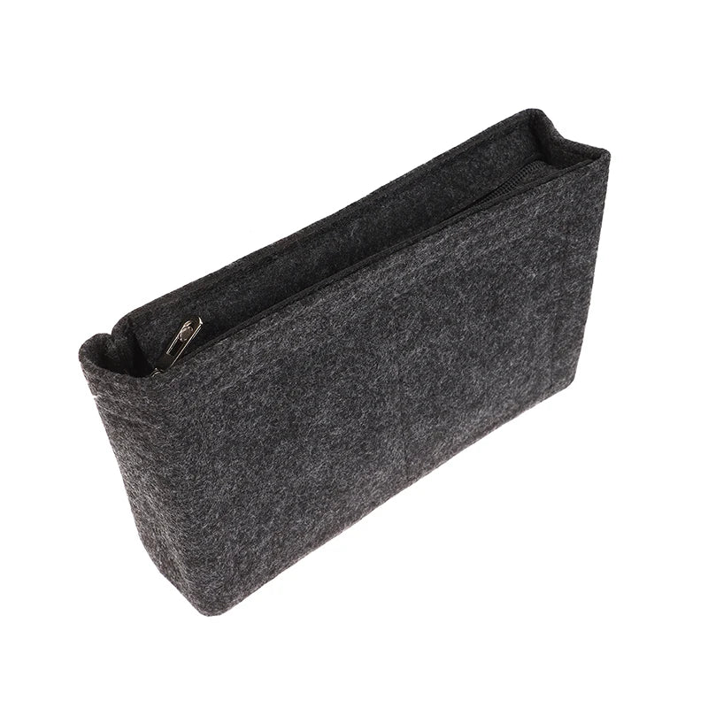 A dark gray felt cosmetic bag insert organizer with a zippered opening.