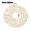 A strand of small, round cream-colored pearls on a gold-toned strap for a handbag or purse.