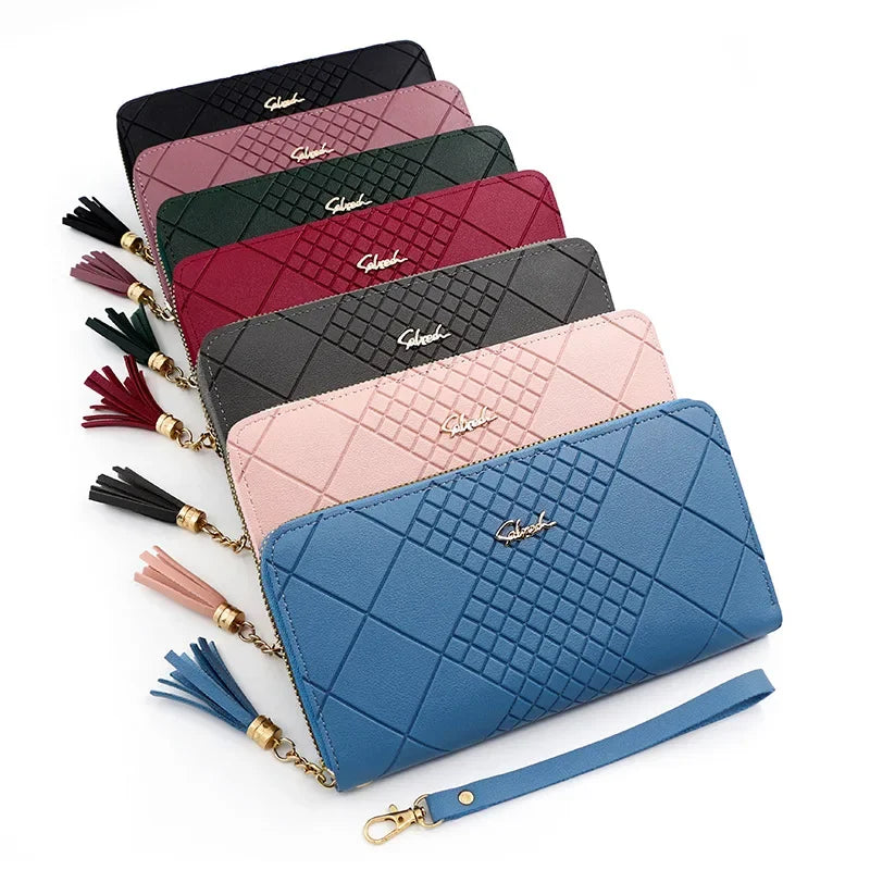 A stack of elegant PU leather clutch wallets in various shades of pink, maroon, and blue with gold accents.