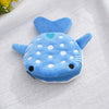 A small blue shark plush coin purse wallet with a soft texture and white polka dots