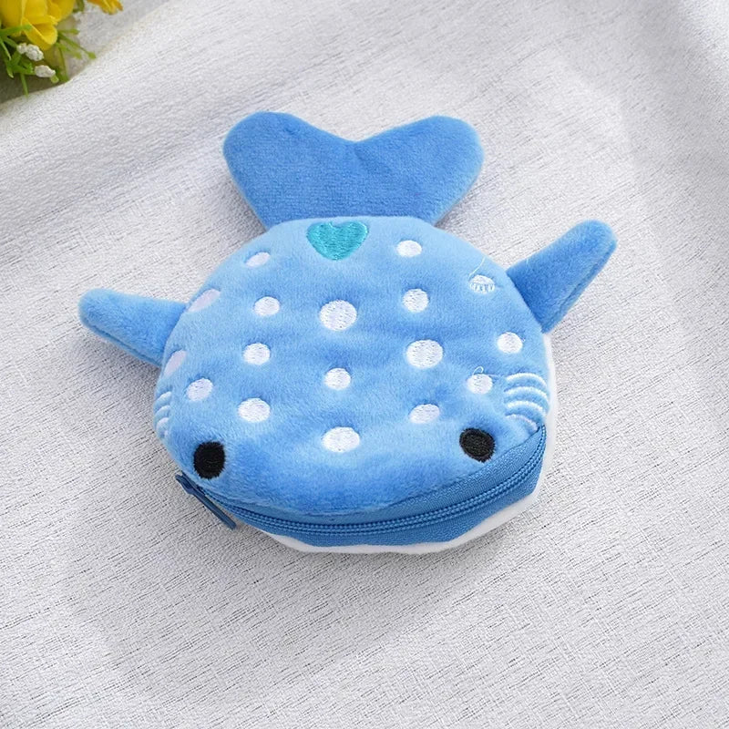 A small blue shark plush coin purse wallet with a soft texture and white polka dots