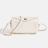 A light beige genuine leather square shoulder crossbody bag with gold hardware.