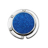 A round, shiny metal desk hook with a vibrant blue glitter finish.