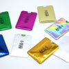 A collection of various colored and metallic card sleeves for RFID protection.