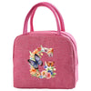 A pink insulated canvas lunch bag featuring a floral butterfly design.