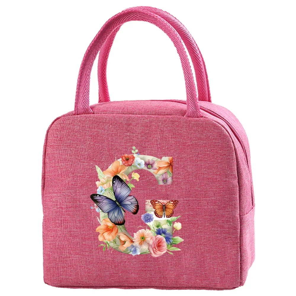 A pink insulated canvas lunch bag featuring a floral butterfly design.