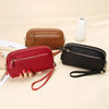 A set of brown and red leather double-zip wristlet wallets displayed on a light background.