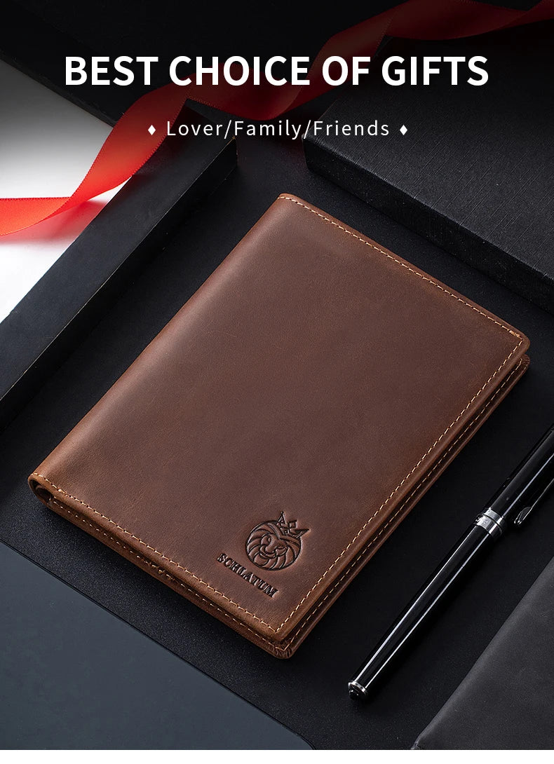 A brown genuine leather passport and travel wallet resting on a black box with a pen.
