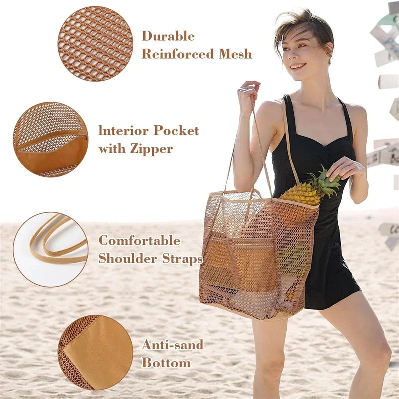 A woman holds a woven mesh beach tote bag with woven shoulder straps on a sandy beach.