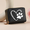 Black faux leather heart-shaped zipper wallet with gold hardware and a white paw print design