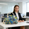 A woman sits at a desk with a multi-color Oxford cloth picnic lunch bag on the table.