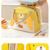 A yellow insulated thermal lunch bag with a bear design is shown being held, next to a glass container of food.