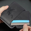 A hand holds a black embossed PU leather slim wallet with a silver card inside.