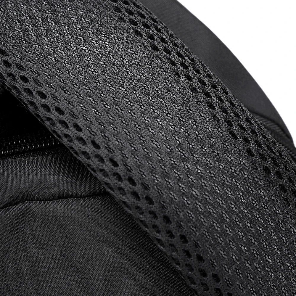 Close-up of a black durable unisex leisure shoulder backpack fabric with a mesh pattern.