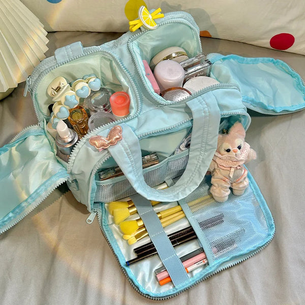 A light blue portable makeup organizer bag filled with various cosmetic products and tools.
