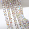 Strands of clear and iridescent AB faceted crystal glass beads in a wheel shape for jewelry making