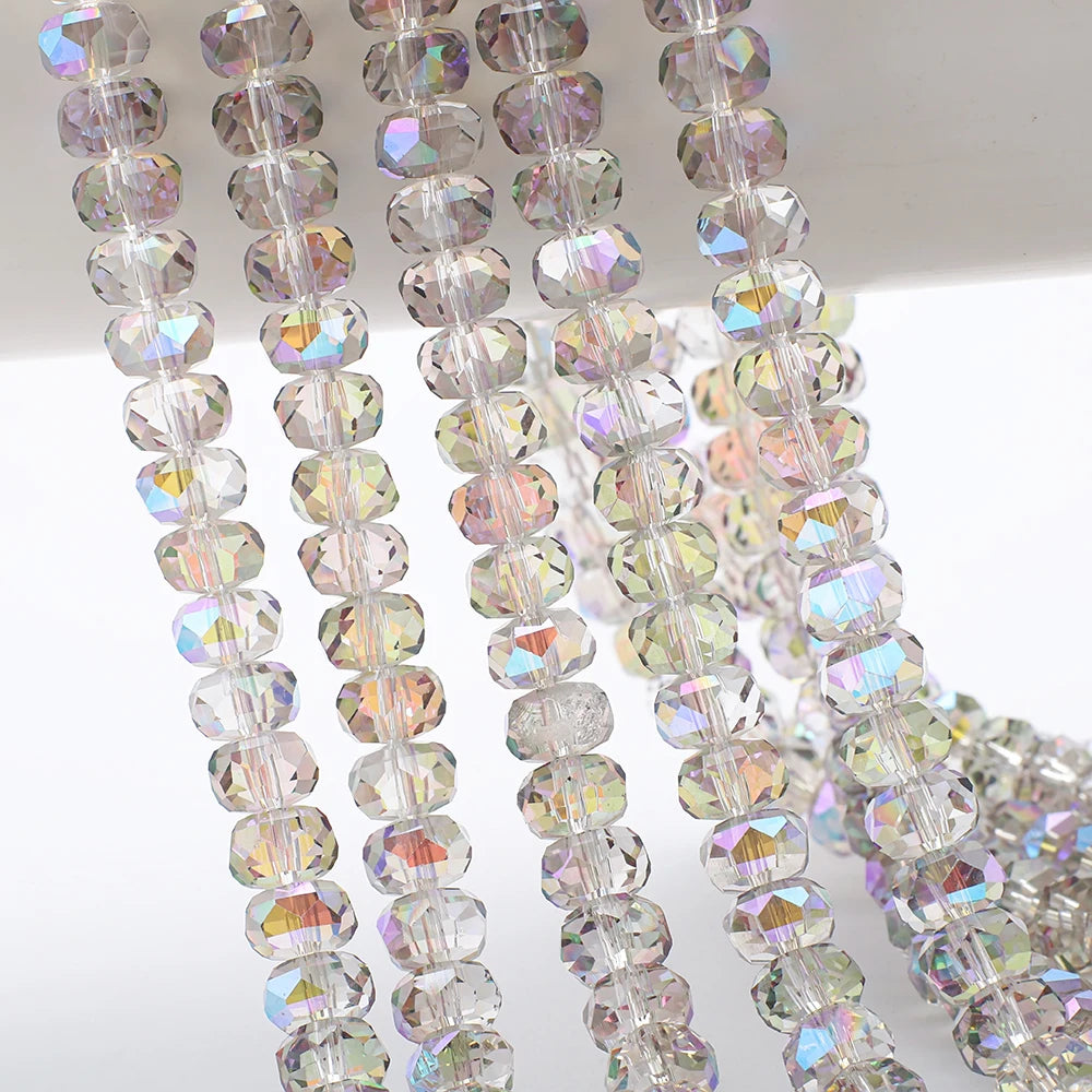 Strands of clear and iridescent AB faceted crystal glass beads in a wheel shape for jewelry making