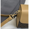 A tan Michael Kors letter square crossbody bag with gold hardware shown against a gray fabric background.