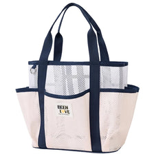 A beige mesh beach tote bag with dark navy handles and trim.