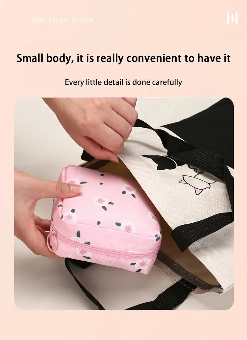 A pink portable pouch for storing sanitary napkins is being held by a hand, shown next to a black and white bag.