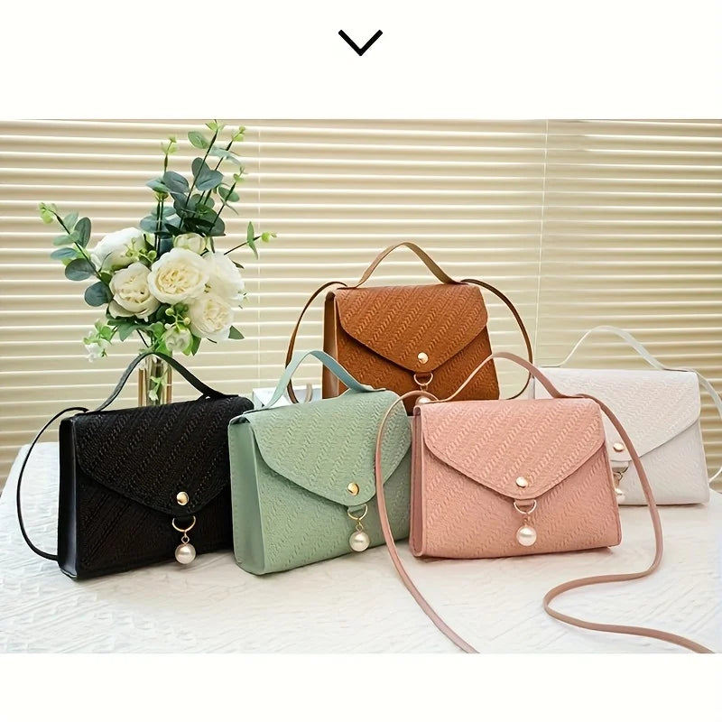 A collection of five beaded square crossbody bags in shades of brown, green, pink, and beige displayed on a white surface.