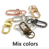 Eine Sammlung von Metall-Swivel-Klammern in verschiedenen Farben, darunter Roségold, Silber und Goldtönen.