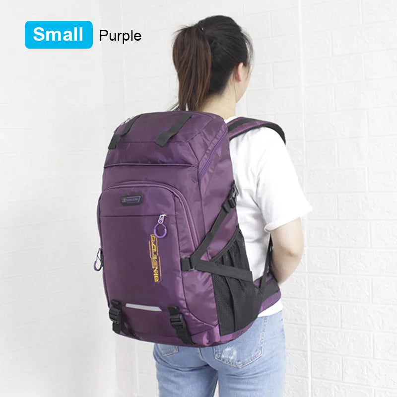 A purple travel backpack with a black rain cover is shown from the back against a white wall.