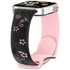Una correa de silicona rosa con estampados florales negros para un reloj inteligente.