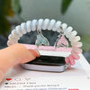 A hand holds a white and pink elastic watch strap for a Huawei band next to a smartphone.
