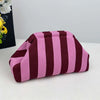 A makeup bag with a striped pattern in shades of pink and deep burgundy.