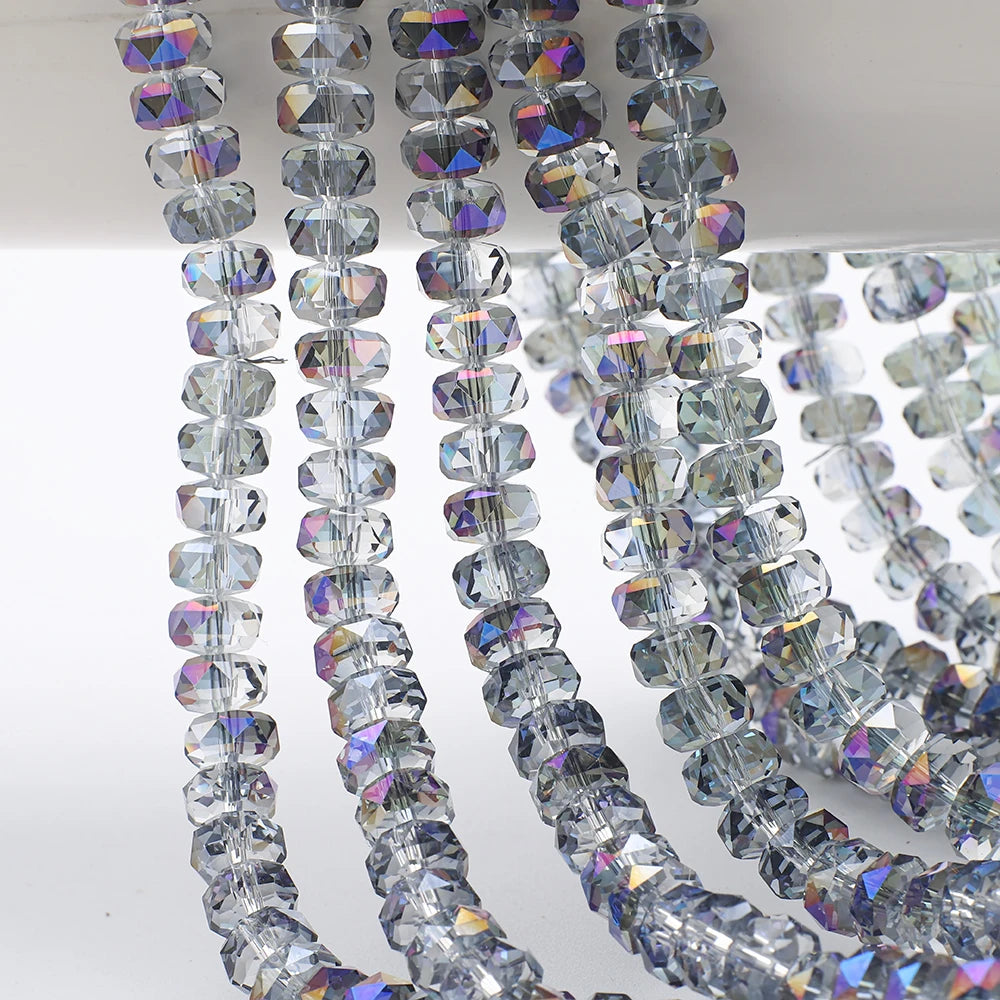 A close-up of clear and iridescent faceted crystal glass beads strung together in strands for jewelry making.