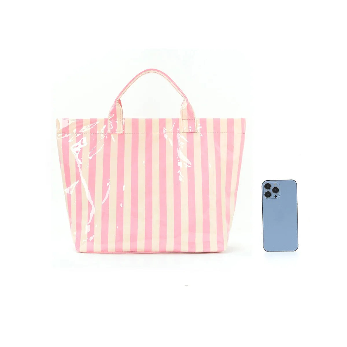A pink and white striped canvas tote bag with pink handles next to a light blue smartphone.