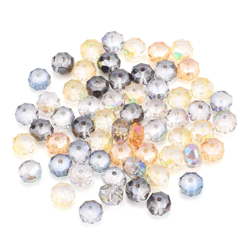 A pile of faceted crystal glass beads in various shades of clear, yellow, and purple tones.