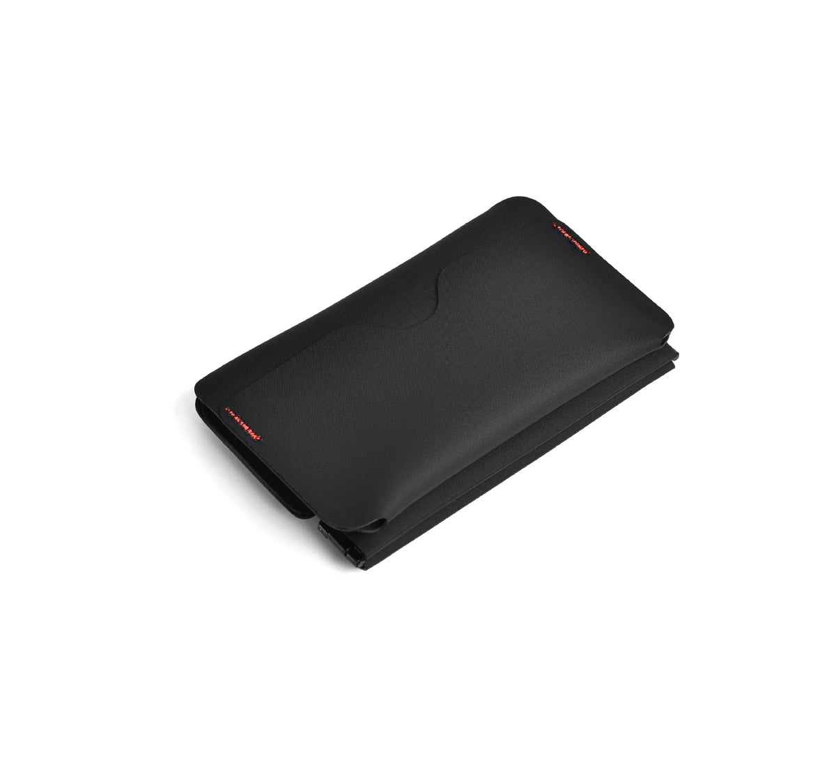 A black magnetic foldable ID card holder and coin purse shown from above.
