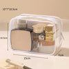 A clear PVC toiletry bag with a secure zipper containing various cosmetic and grooming products.