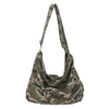A canvas camouflage shoulder bag with an adjustable strap.