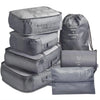 A set of seven gray folding travel organizer storage bags.