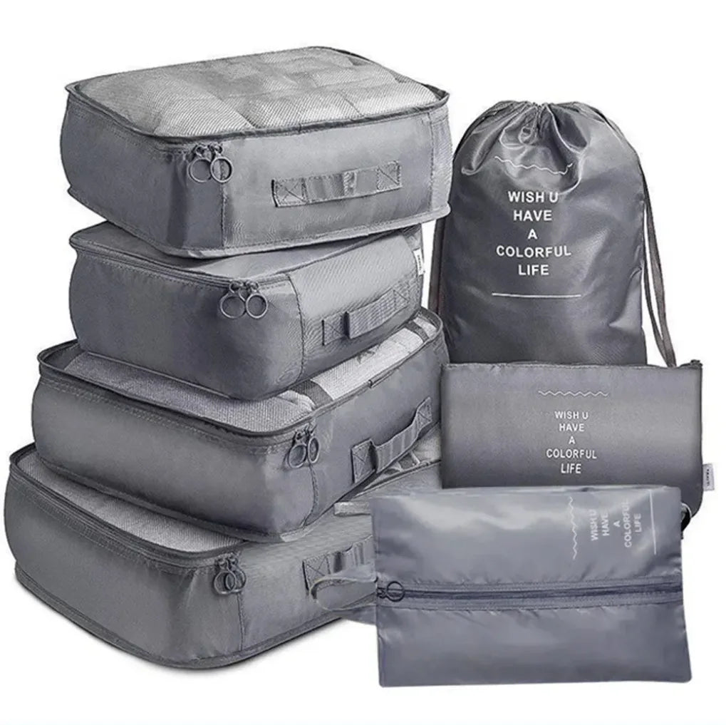 A set of seven gray folding travel organizer storage bags.
