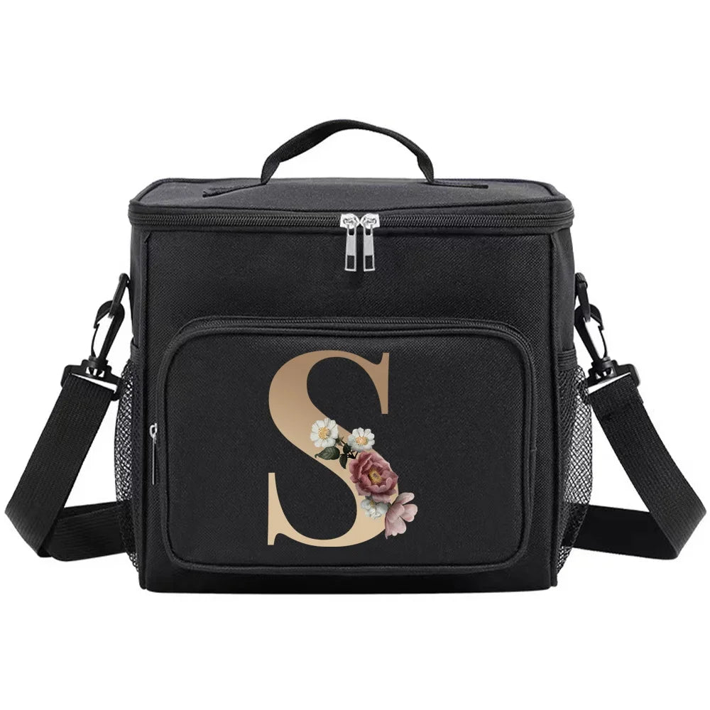 Black insulated canvas lunch bag with dual handles featuring a gold initial S and floral accents.