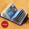 A stack of clear plastic cards, including a credit card and ID, is displayed in a black leather wallet on a wooden surface.