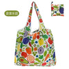 A colorful reusable shopping tote bag featuring various fruits and vegetables like apples, oranges, and leafy greens.