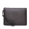 A dark brown leather clutch wallet with a zipper and a leather strap is shown against a white background.