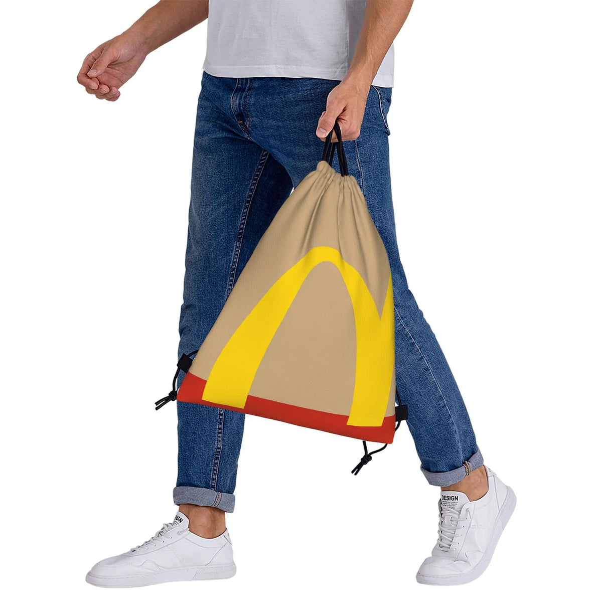 A person is holding a beige kraft paper drawstring bag with yellow accents.