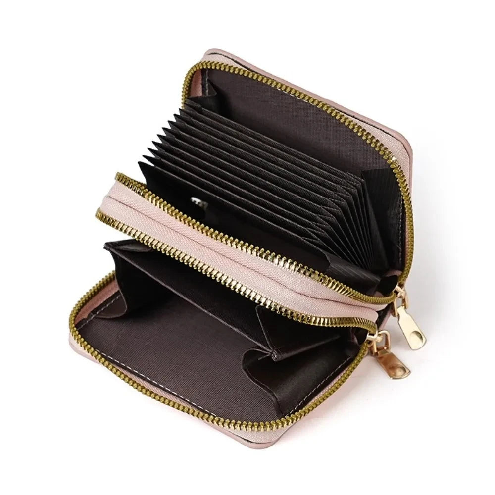 A brown leather zipper wallet with multiple card slots and a light pink accent.