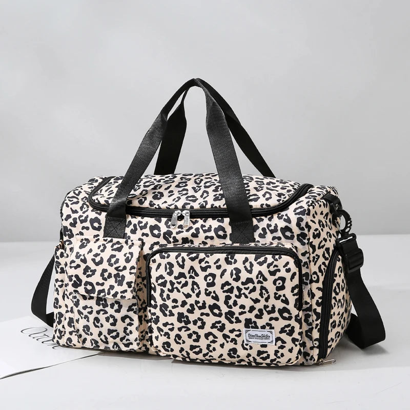 A beige leopard print travel duffel bag with a separate shoe compartment and black straps.