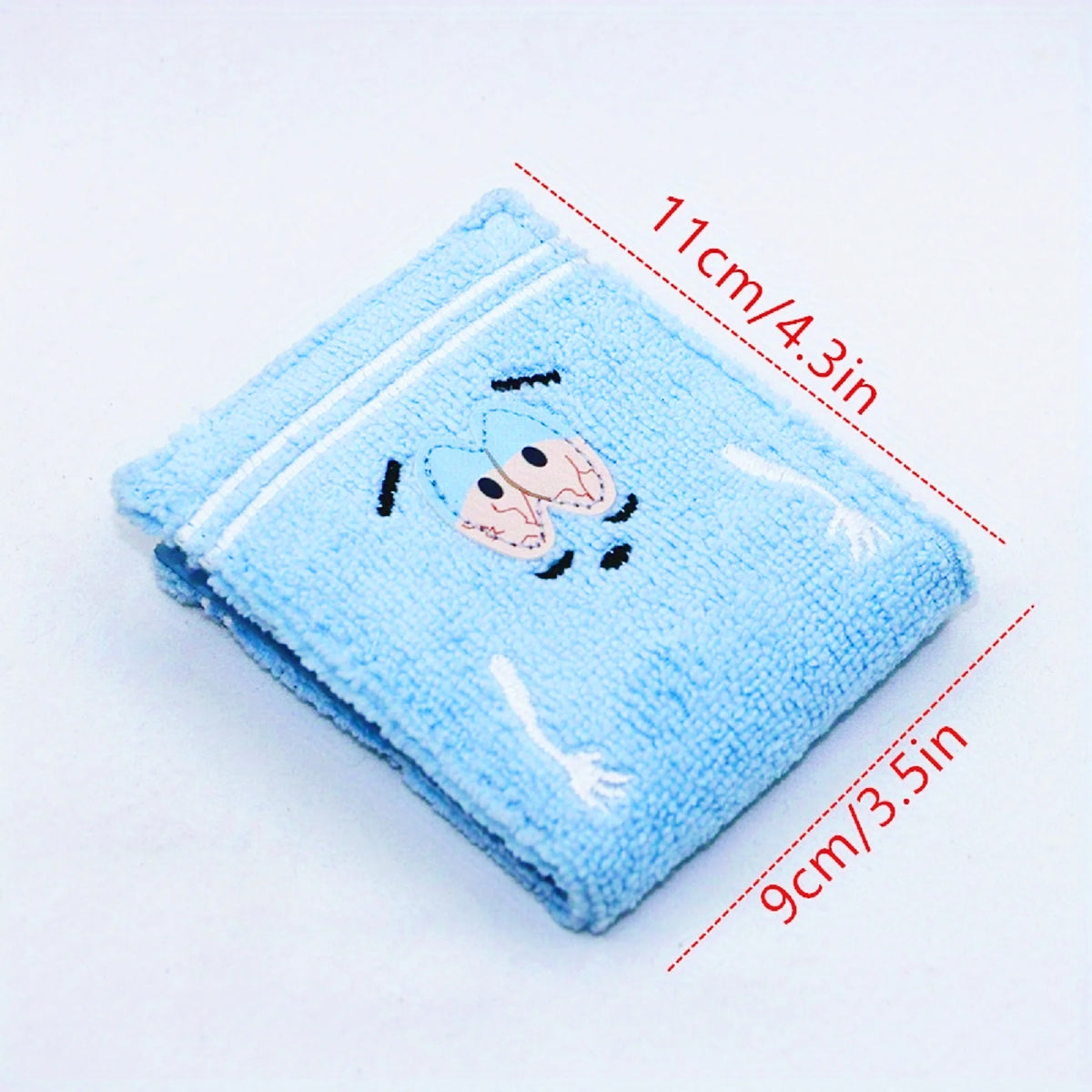 Light blue fabric wallet embroidered with a small animal design