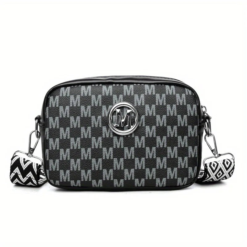 Black faux leather crossbody bag with a repeating monogram pattern and silver hardware