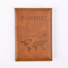A brown leather passport holder with the word PASSPORT embossed and a silhouette of the world map.