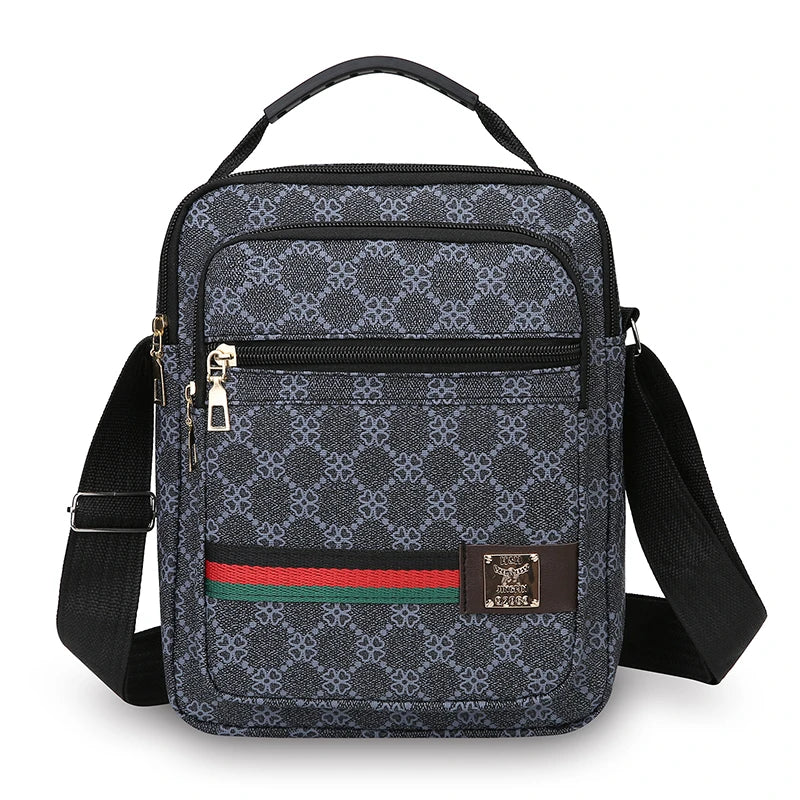 A black patterned sling bag with a black strap and gold hardware.