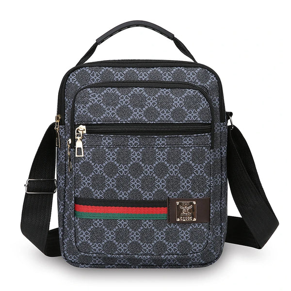 A black patterned sling bag with a black strap and gold hardware.